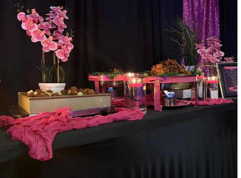 Hot Buffet Flavor and Flair Catering buffet with chafing dishes, hot wings, and pink floral decor
