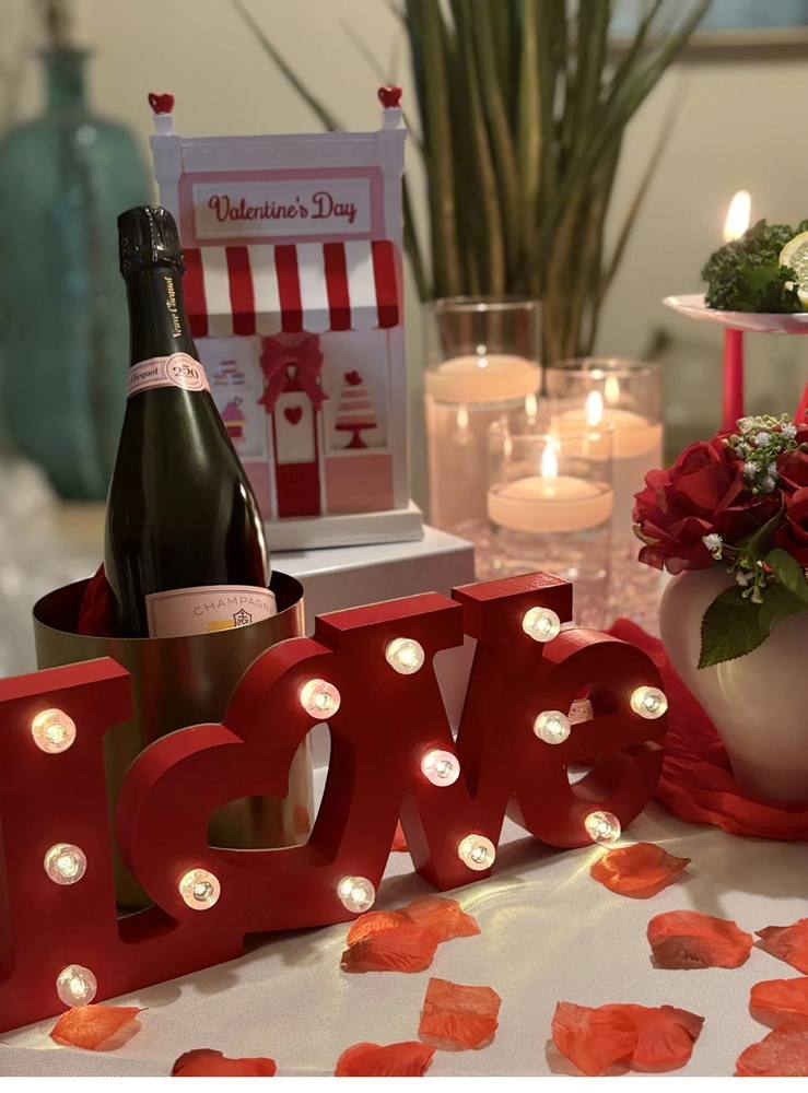 Romantic Champagne Table Setup Flavor and Flair Catering romantic table with Veuve Clicquot champagne and lighted LOVE sign