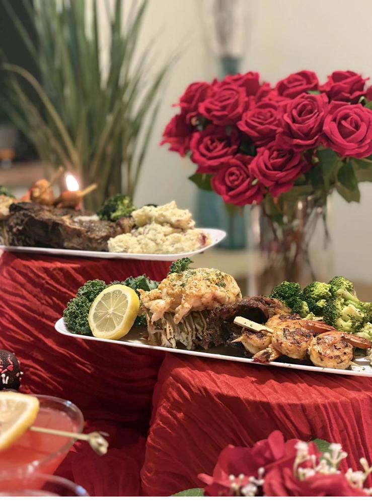 Romantic Steak and Lobster Dinner Flavor and Flair Catering romantic dinner with steak, lobster, and red rose centerpiece